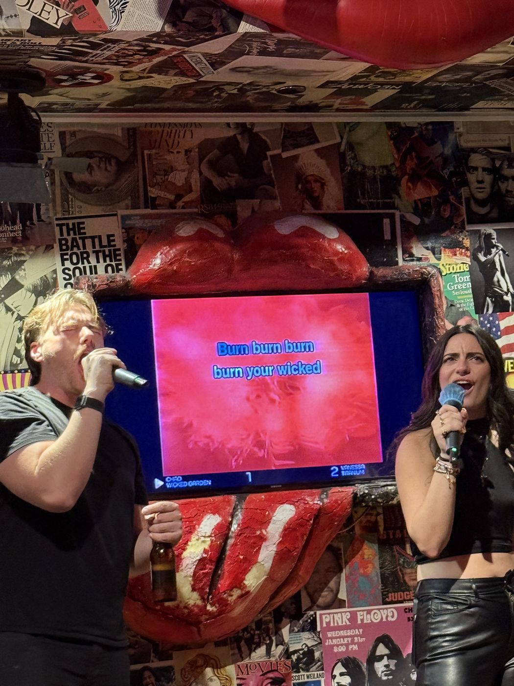 A duet singing under the giant lips screen at Planet Rose